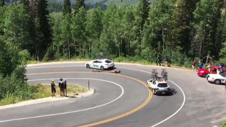 Cyclist racing downhill crashes into moving car